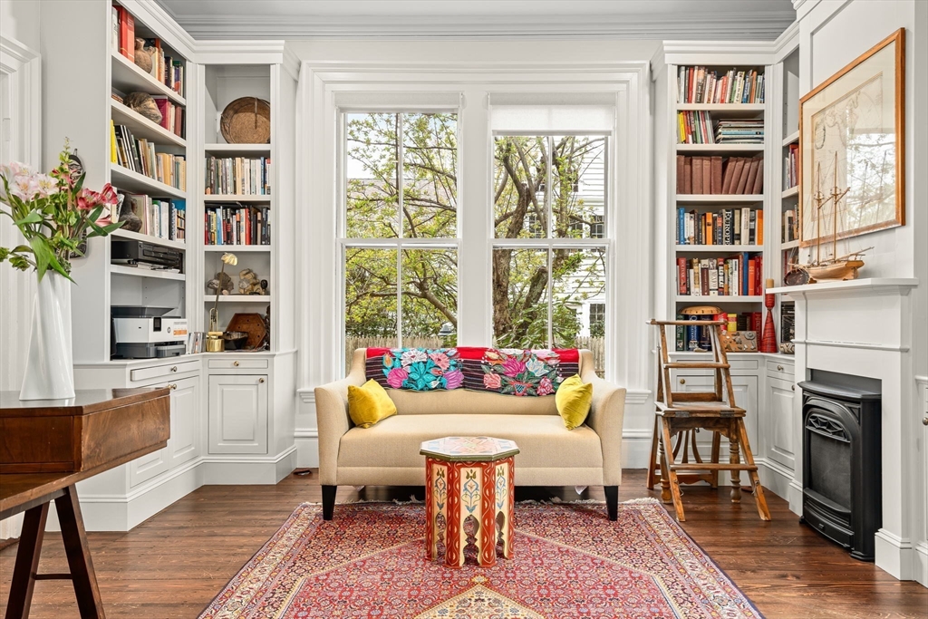 135 Court Street Dedham, MA 02026 - Photo 6 of 40 a living room with fireplace furniture and a book shelf