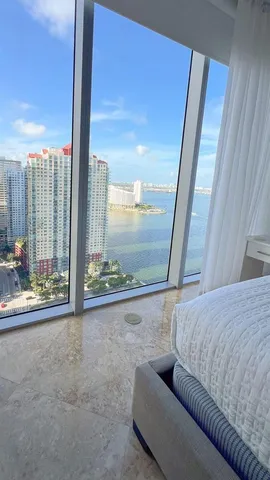 a living room with furniture and a floor to ceiling window