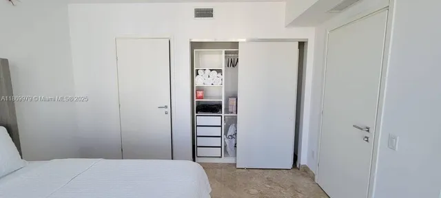 a bedroom with a bed and a closet