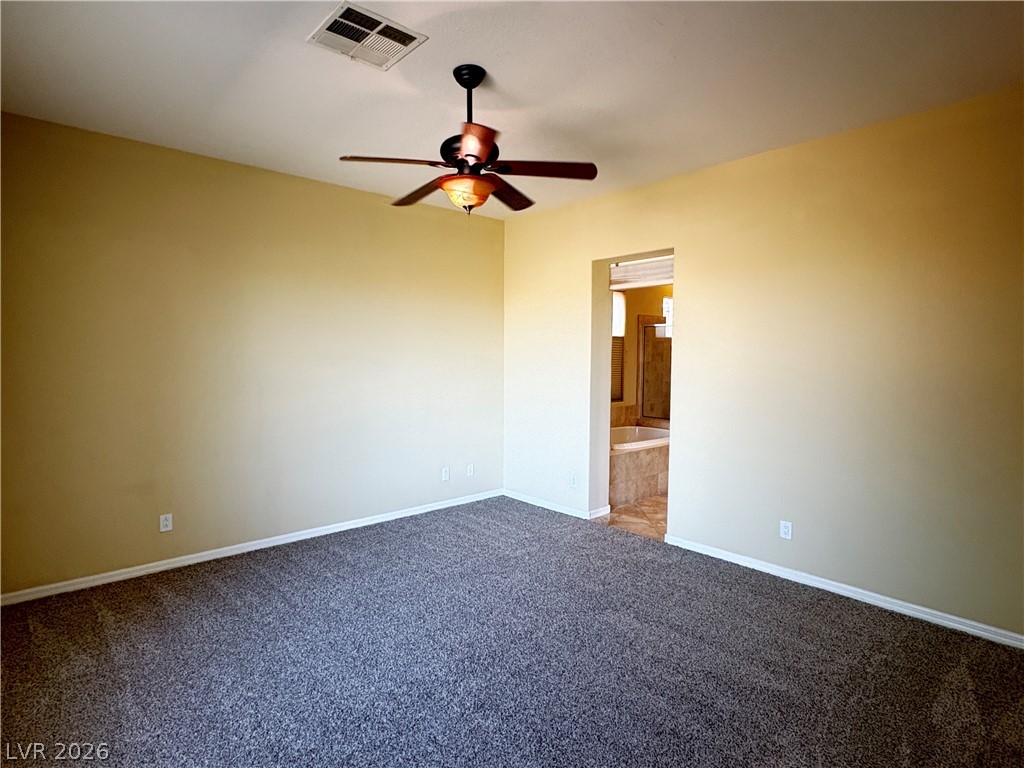 10 Caprington Road Henderson, NV 89052 - Photo 9 of 44 A quiet retreat with plush carpeting and a convenient en-suite bath access awaits.