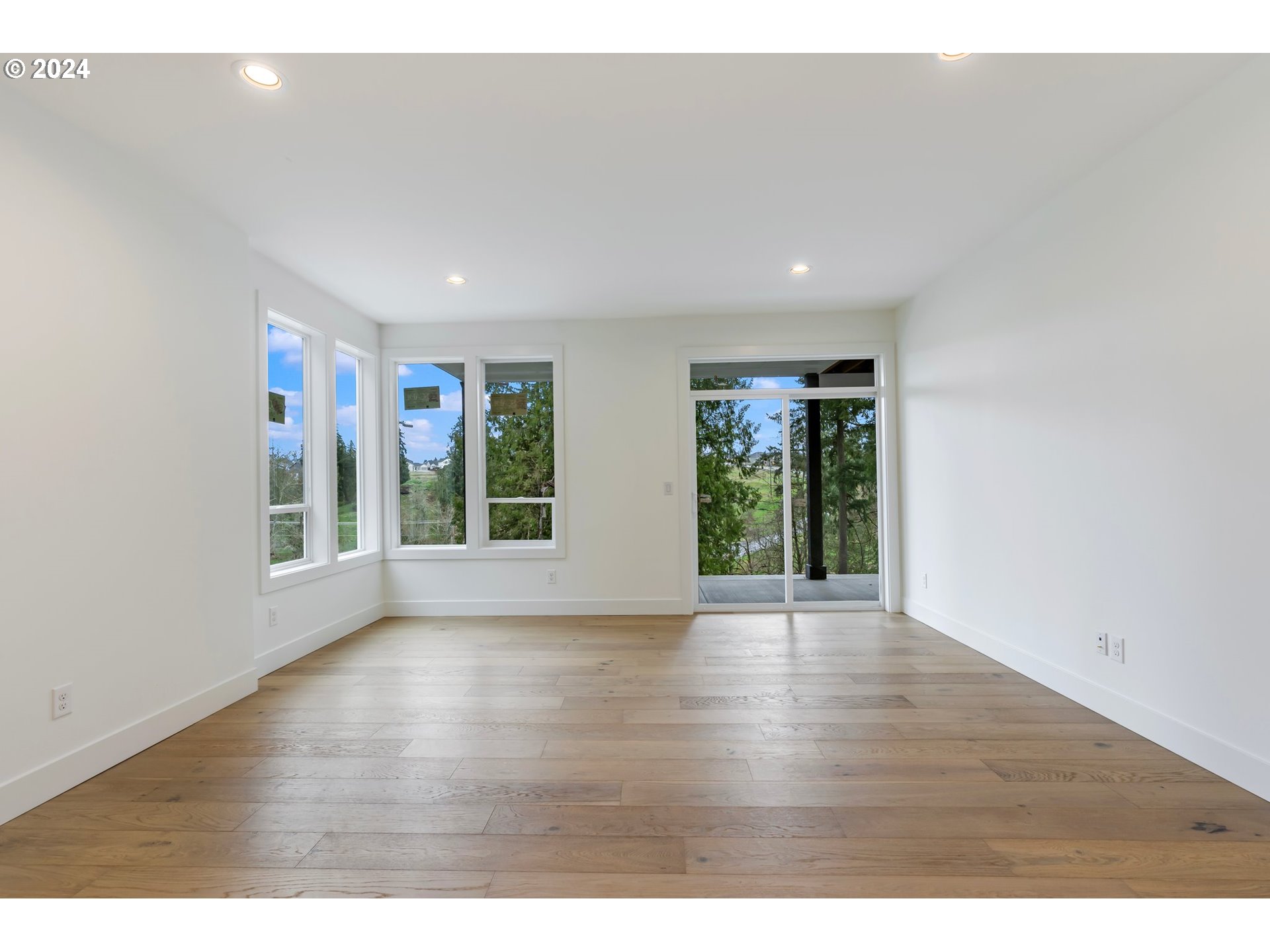 4117 South Hay Field Circle Ridgefield, WA 98642 - Photo 31 of 44 a view of an empty room with wooden floor and windows