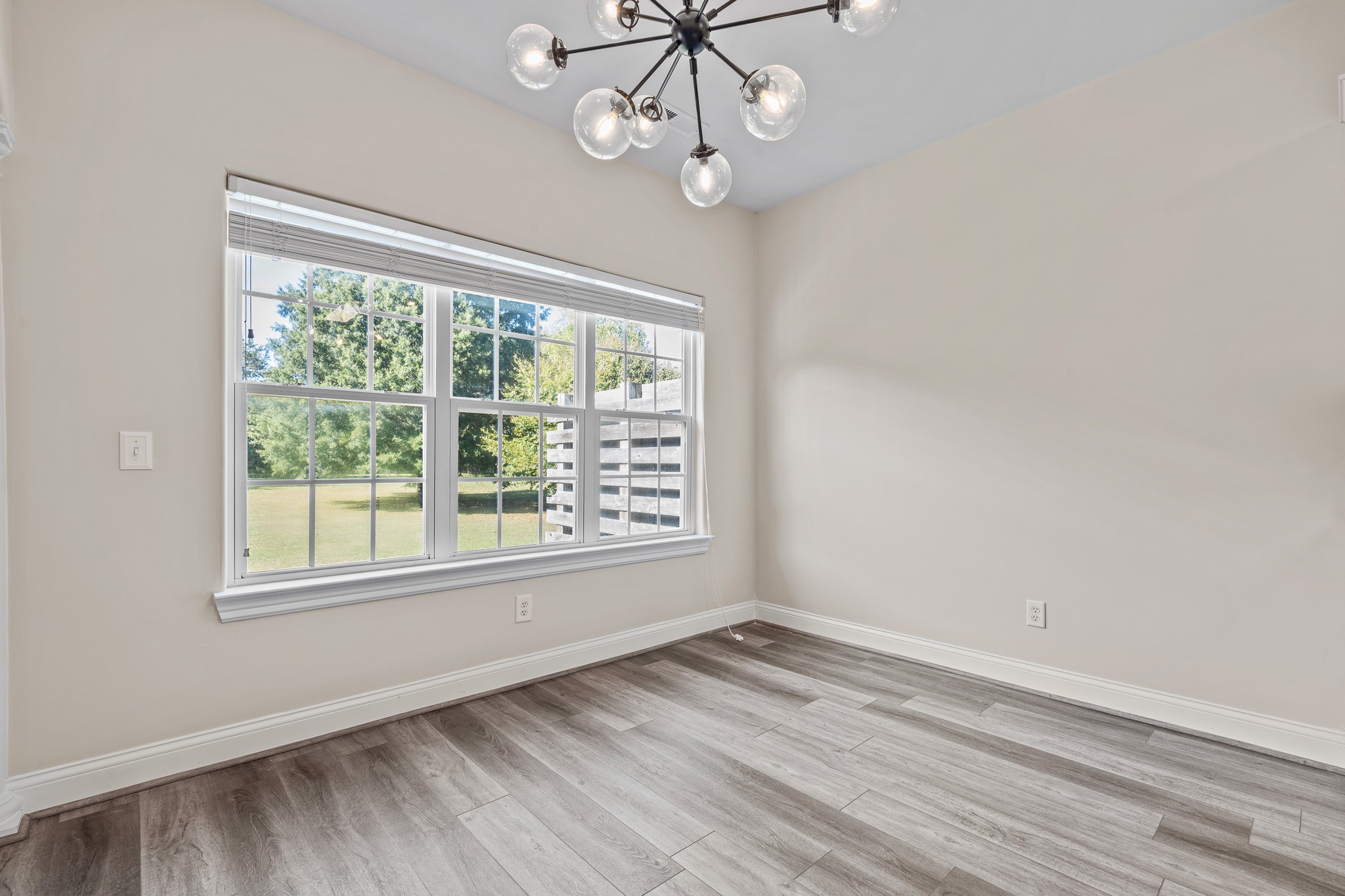 2521 Pennington Bend Road, Unit 119 Nashville, TN 37214 - Photo 19 of 47 an empty room with wooden floor fan and windows