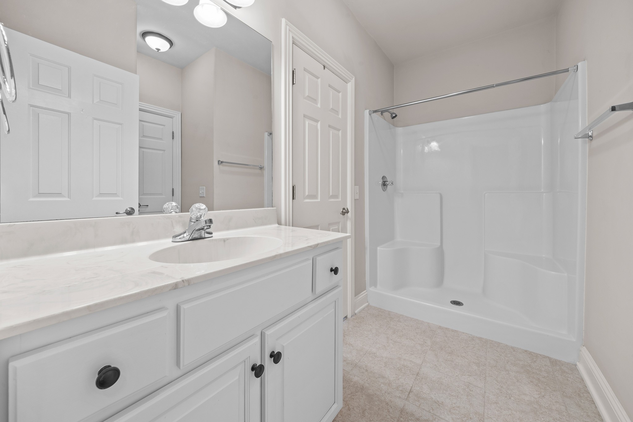 2521 Pennington Bend Road, Unit 119 Nashville, TN 37214 - Photo 20 of 47 a bathroom with a shower sink vanity and mirror