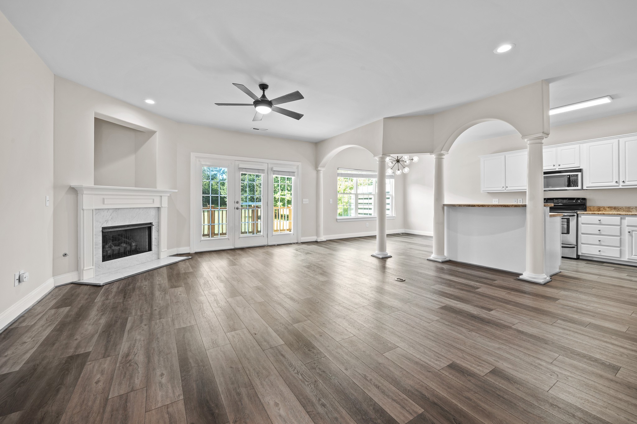 2521 Pennington Bend Road, Unit 119 Nashville, TN 37214 - Photo 9 of 47 an empty room with wooden floor fireplace and windows