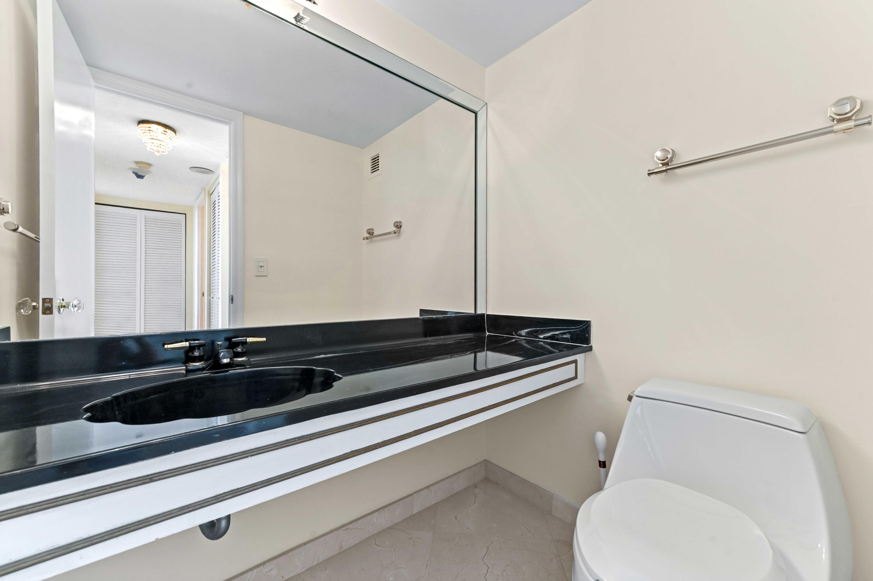 2800 South Ocean Boulevard, Unit 11M Boca Raton, FL 33432 - Photo 21 of 65 a bathroom with a sink and a toilet