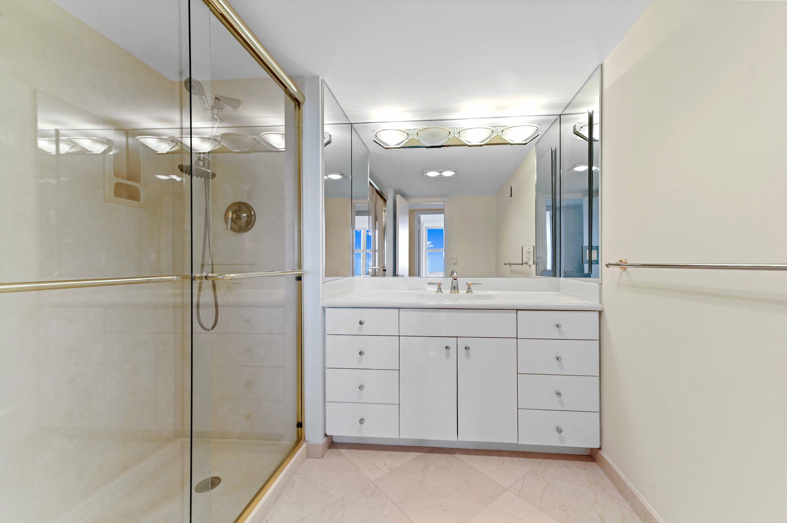 2800 South Ocean Boulevard, Unit 11M Boca Raton, FL 33432 - Photo 25 of 65 a bathroom with a shower sink and mirror