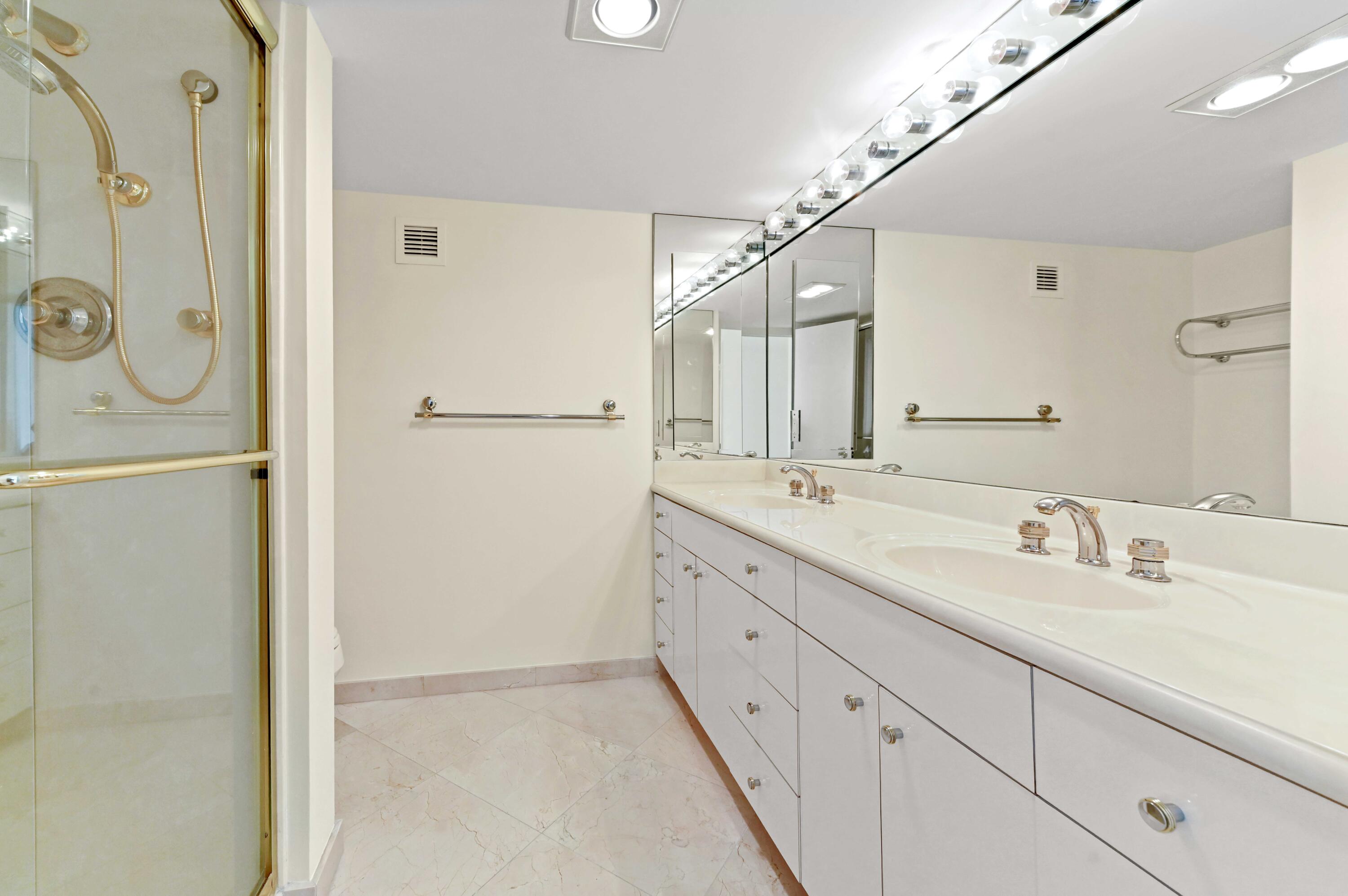 2800 South Ocean Boulevard, Unit 11M Boca Raton, FL 33432 - Photo 31 of 65 a bathroom with a double vanity sink and mirror
