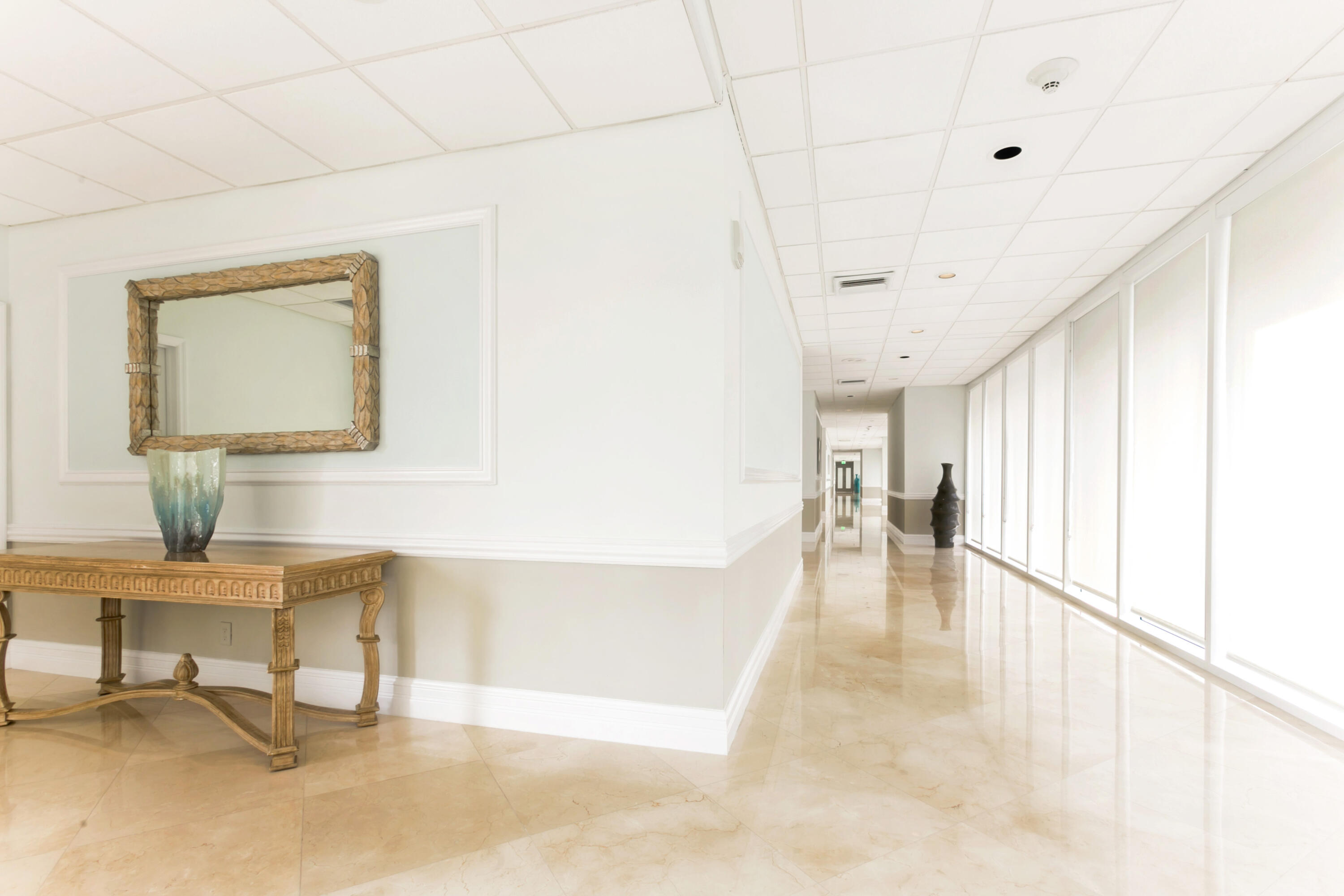 2800 South Ocean Boulevard, Unit 11M Boca Raton, FL 33432 - Photo 46 of 65 a view of a hallway with wooden floor and a potted plant