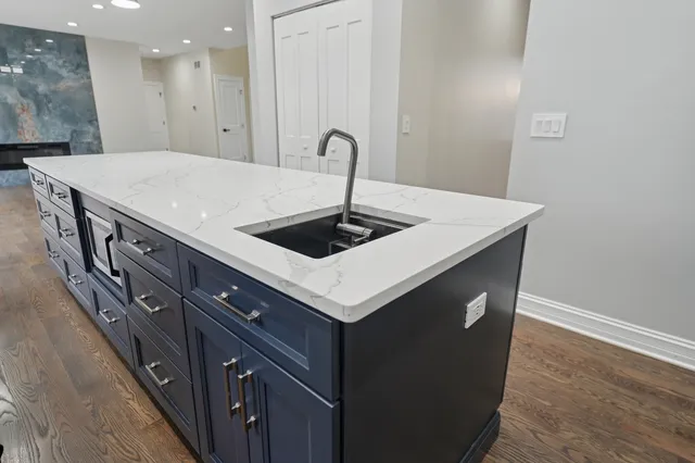 a kitchen with a stove a sink and a refrigerator