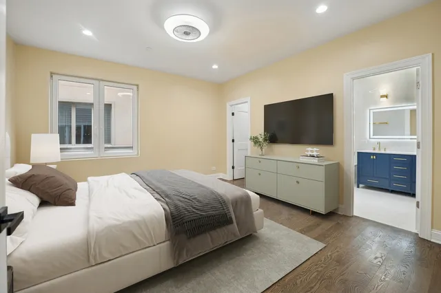 a bedroom with a bed and a flat screen tv