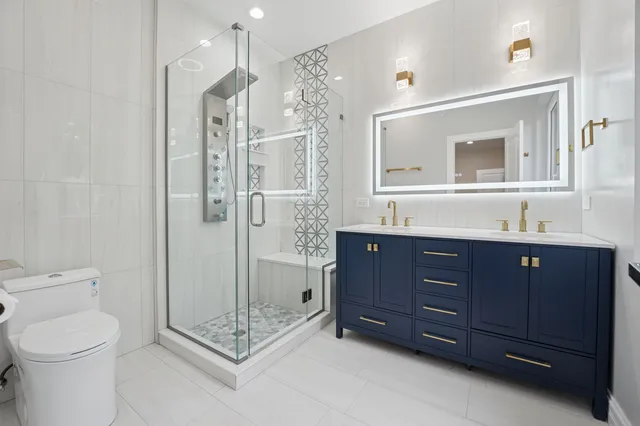 a bathroom with a toilet sink and shower