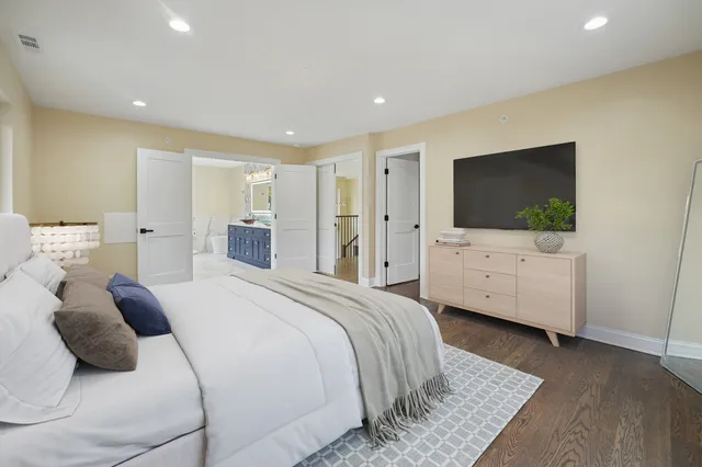 a bedroom with a bed and a flat screen tv
