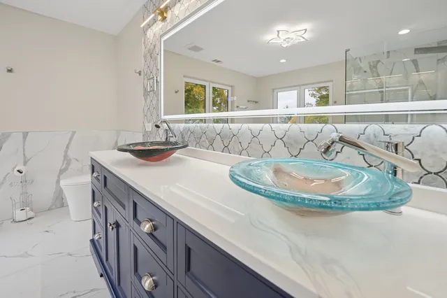 a kitchen with a sink and a mirror