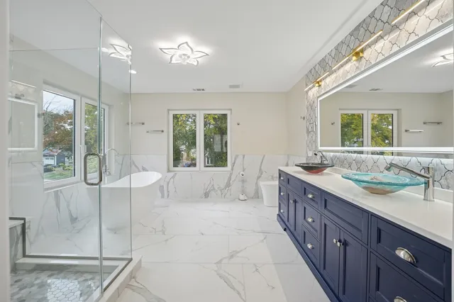 a spacious bathroom with a granite countertop sink mirror and shower