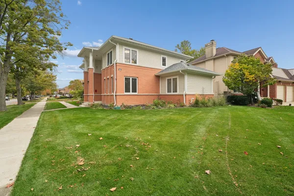 a front view of house with yard and green space