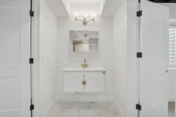 a bathroom with a sink a mirror and a shower