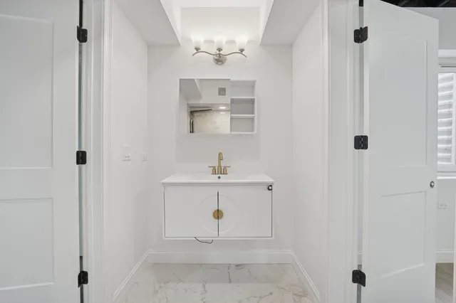 a bathroom with a sink a mirror and a shower