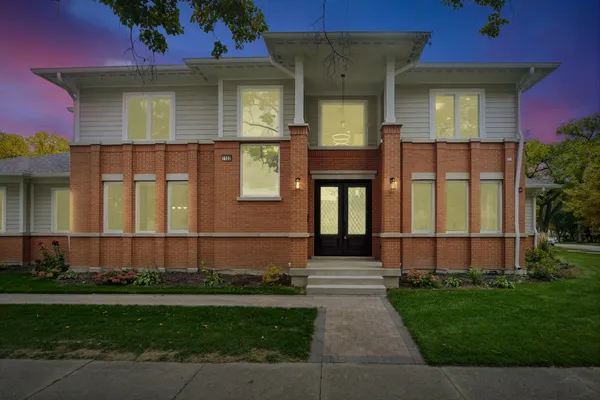a front view of a house with a garden