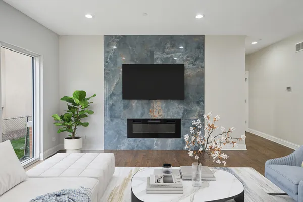 a living room with furniture a fireplace and a potted plant