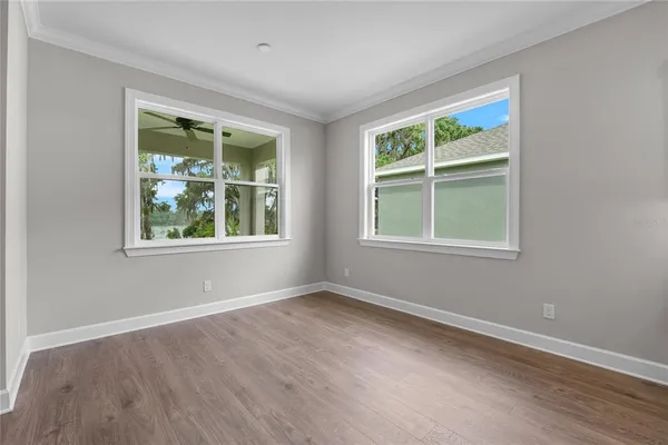 a view of a kitchen with wooden floor and a sink