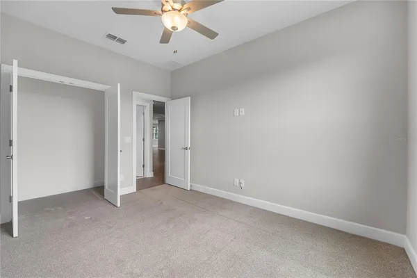 a bathroom with a toilet a sink a mirror a bathtub and vanity