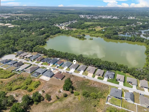 an aerial view of a house with a lake view