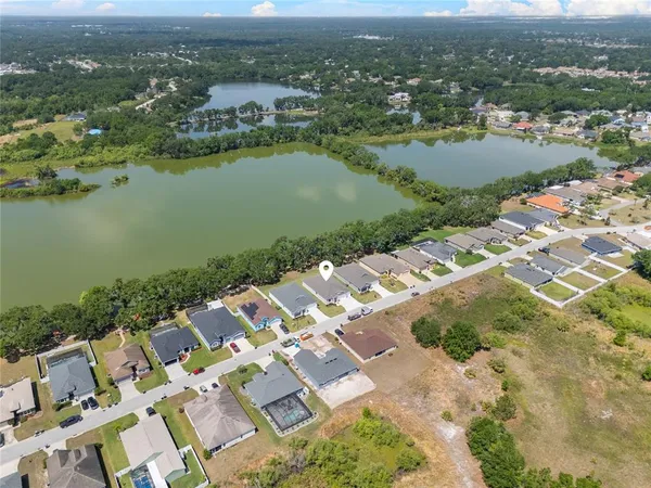 an aerial view of a house with a yard