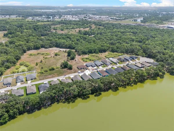 an aerial view of a house with a lake view