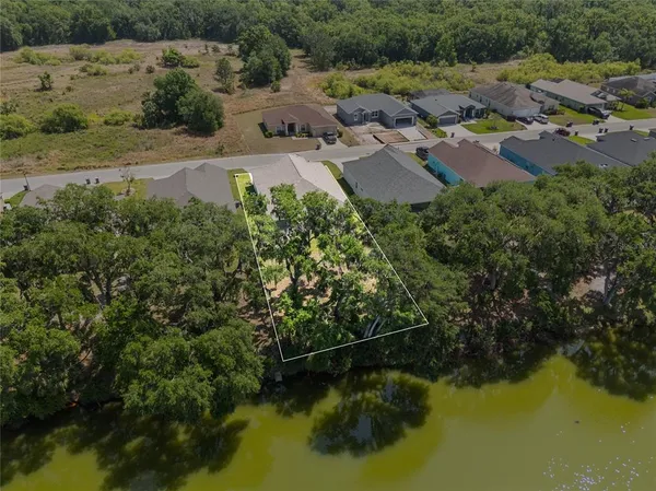 a view of a backyard with swimming pool
