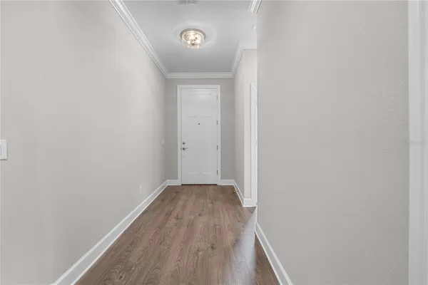 a view of empty room with wooden floor and windows
