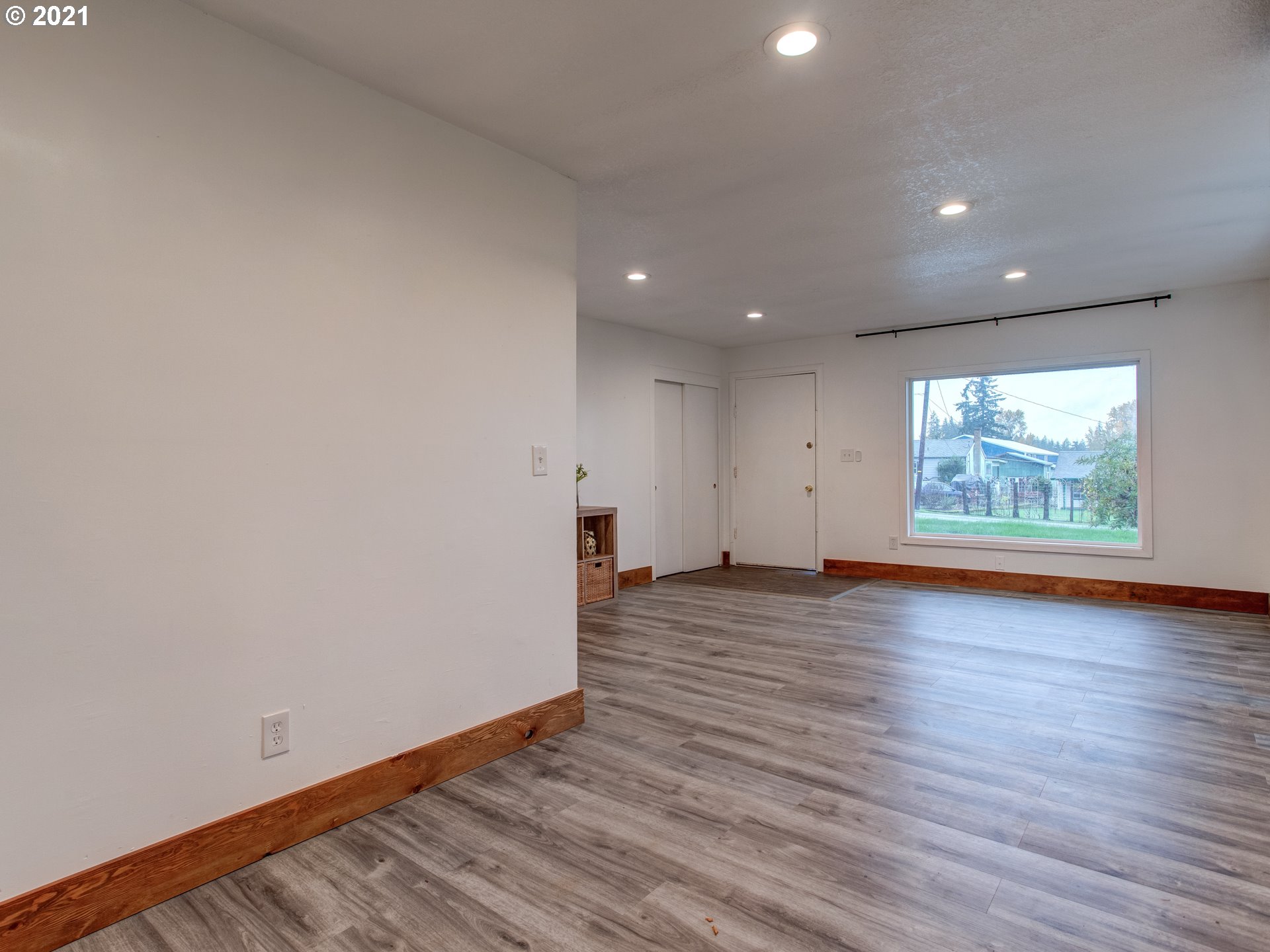 2517 Northeast 199th Street Ridgefield, WA 98642 - Photo 6 of 25 a view of an empty room with wooden floor and a window