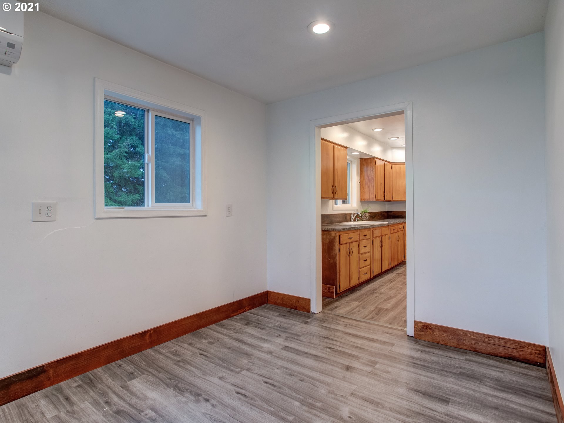 2517 Northeast 199th Street Ridgefield, WA 98642 - Photo 8 of 25 a view of a kitchen from the hallway with wooden floor and a window