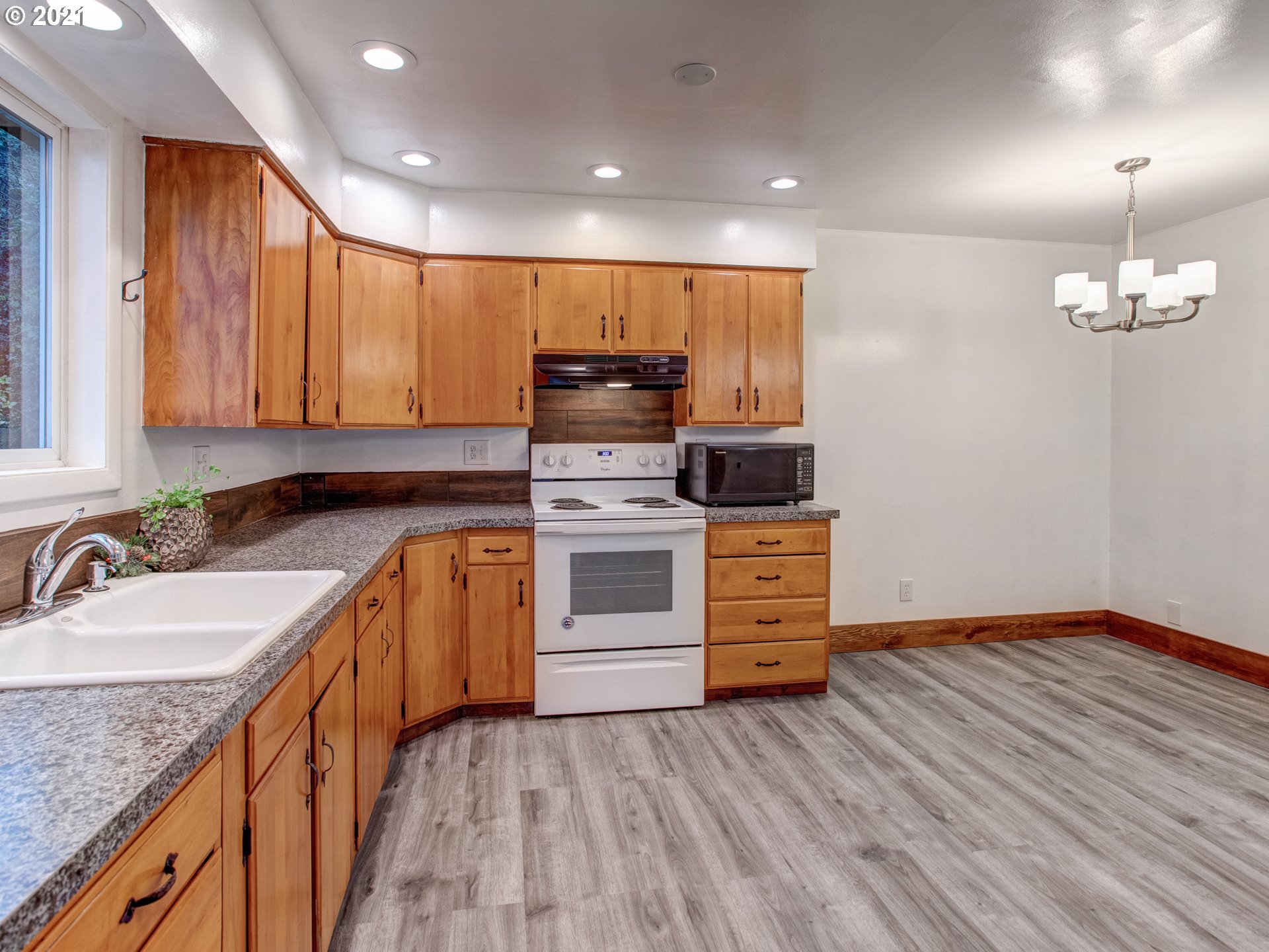 2517 Northeast 199th Street Ridgefield, WA 98642 - Photo 10 of 25 a kitchen with stainless steel appliances granite countertop a sink stove and refrigerator