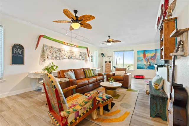 a living room with furniture flowers and a table