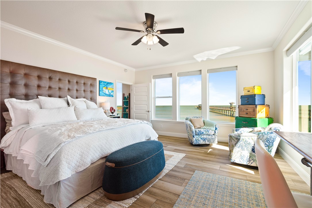 13 Sea Shell Shores Rockport, TX 78382 - Photo 33 of 40 a spacious bedroom with a bed a couch and a large window