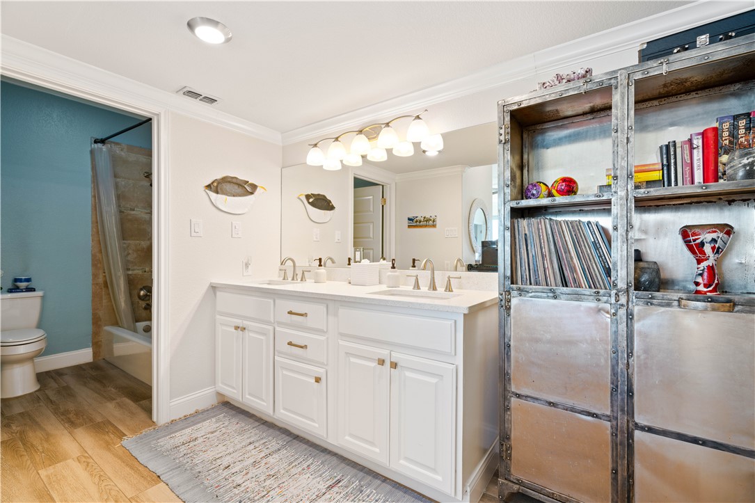 13 Sea Shell Shores Rockport, TX 78382 - Photo 35 of 40 a en suite bathroom with a sink a toilet and a mirror