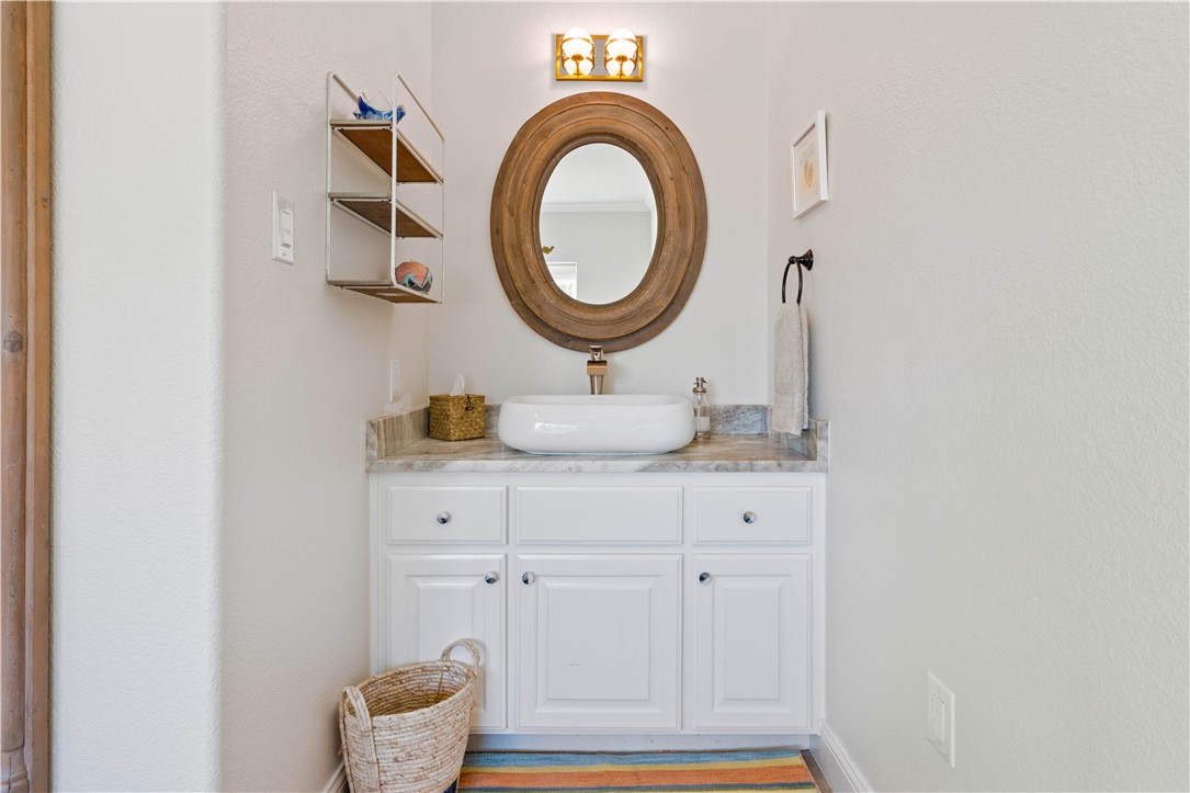 13 Sea Shell Shores Rockport, TX 78382 - Photo 36 of 40 a bathroom with a sink and a mirror