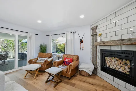 a living room with furniture a fireplace and a table