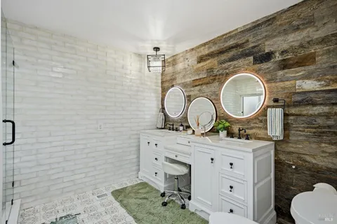 a bathroom with a sink mirror vanity and toilet