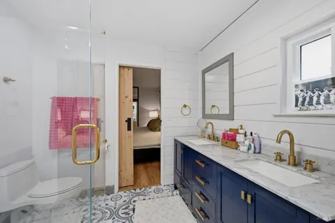 a bathroom with a sink double vanity and toilet