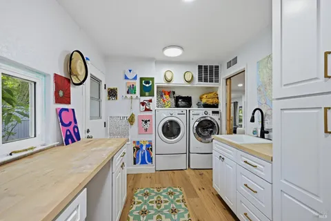a utility room with sink dryer and washer