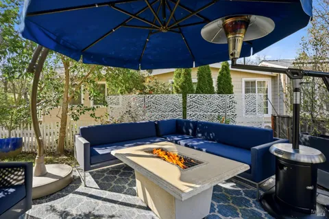 a view of a patio with a table and chairs under an umbrella