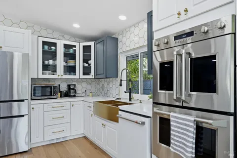 a kitchen with stainless steel appliances kitchen island granite countertop a sink and cabinets