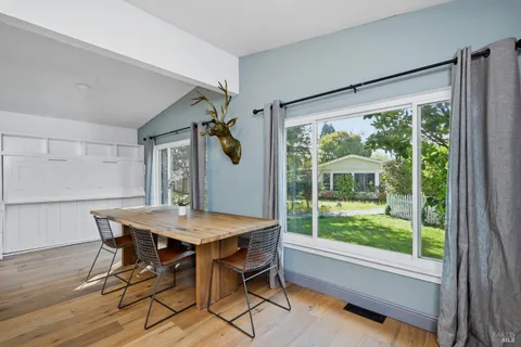 a view of a dining room with furniture window and wooden floor