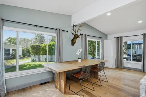 a view of a dining room with furniture window and wooden floor