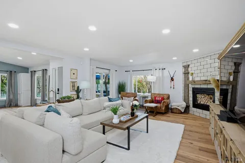 a living room with furniture a fireplace and a flat screen tv