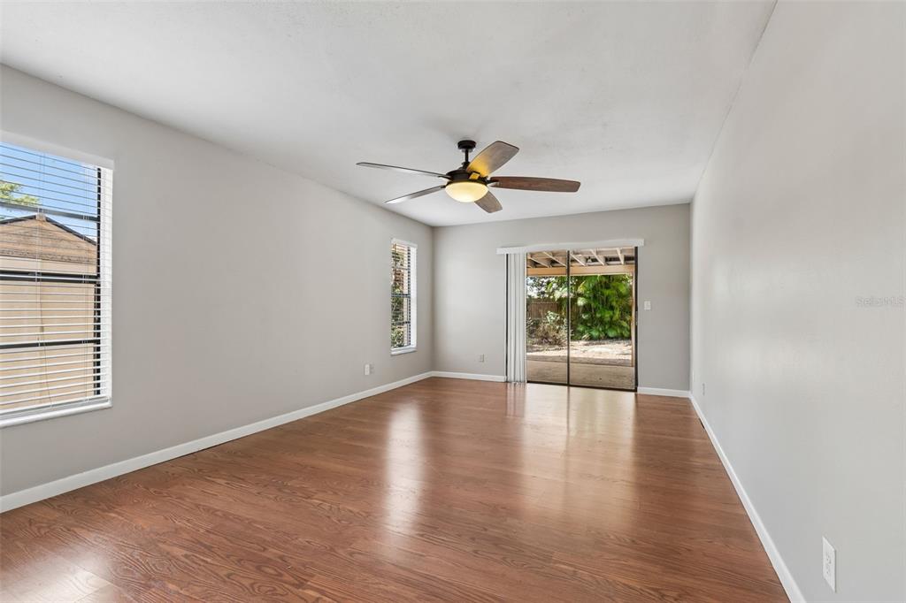 1470 Burnham Lane Dunedin, FL 34698 - Photo 20 of 42 a view of an empty room with wooden floor and a window
