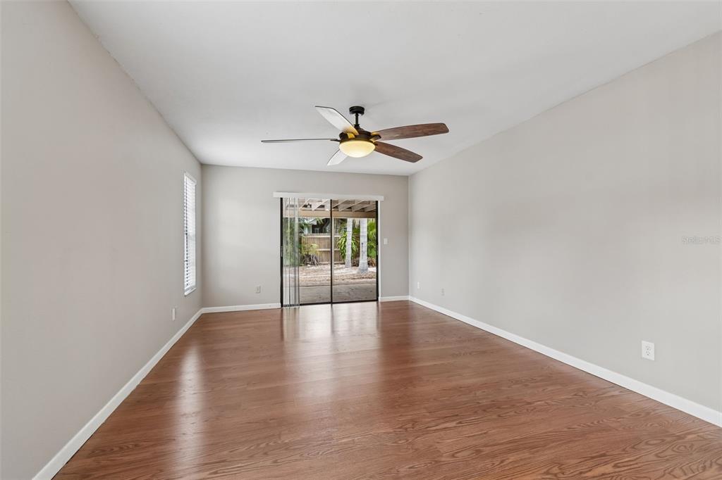 1470 Burnham Lane Dunedin, FL 34698 - Photo 21 of 42 wooden floor in an empty room with a window