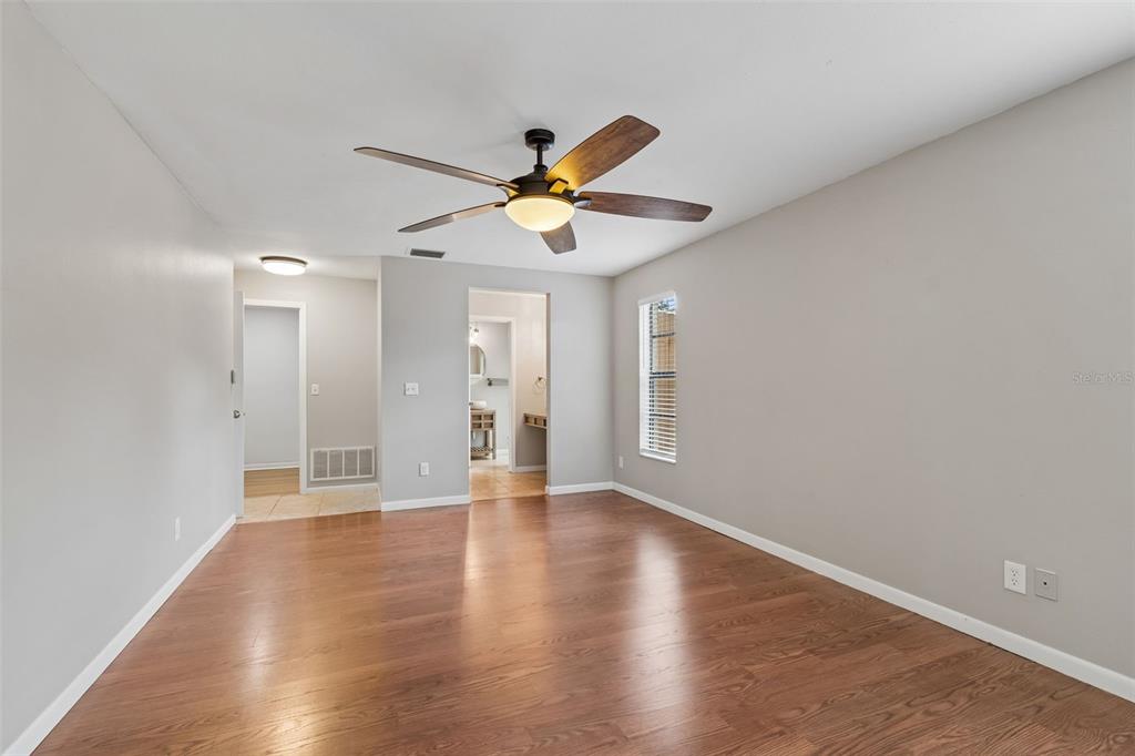 1470 Burnham Lane Dunedin, FL 34698 - Photo 22 of 42 a view of an empty room with window and wooden floor