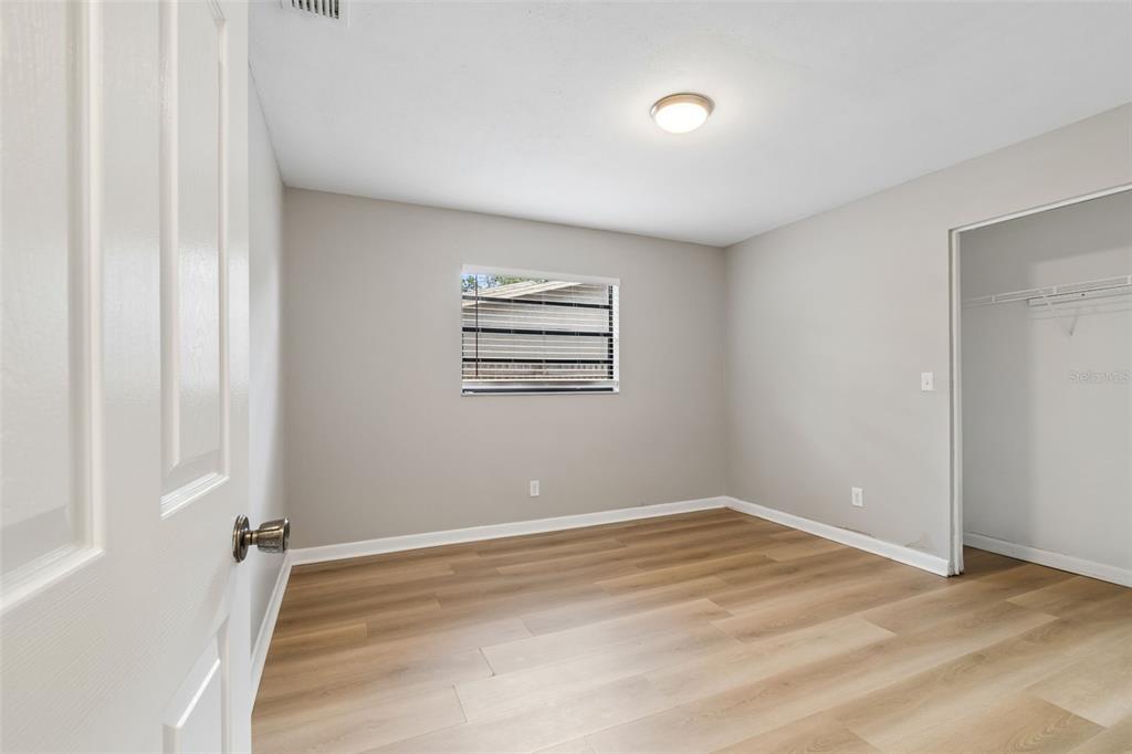 1470 Burnham Lane Dunedin, FL 34698 - Photo 27 of 42 an empty room with windows and closet
